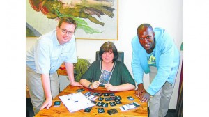 Jörg Spanjer (l) and Sigrid Busch (m) co-creators of The Battle of the Wordsmiths trading card game.  As well as  the game they set up an exhibition of the original artwork at their shop Tabula Magica ib Varel, Germany.